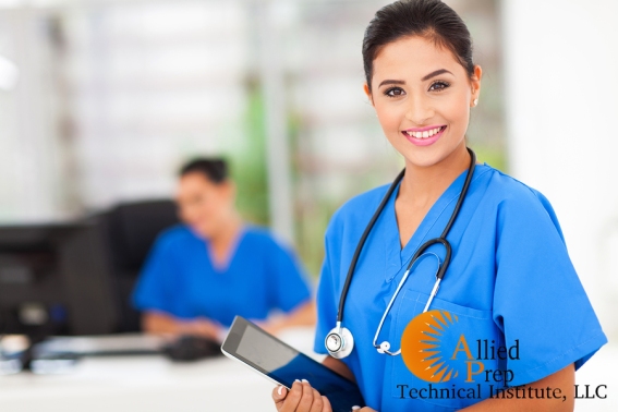 attractive young female nurse holding tablet computer at workpla